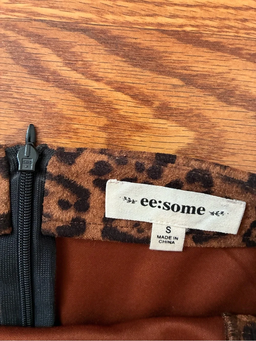eesome Leopard-Print Mini Skirt in Brown and Black with Buckle Accents